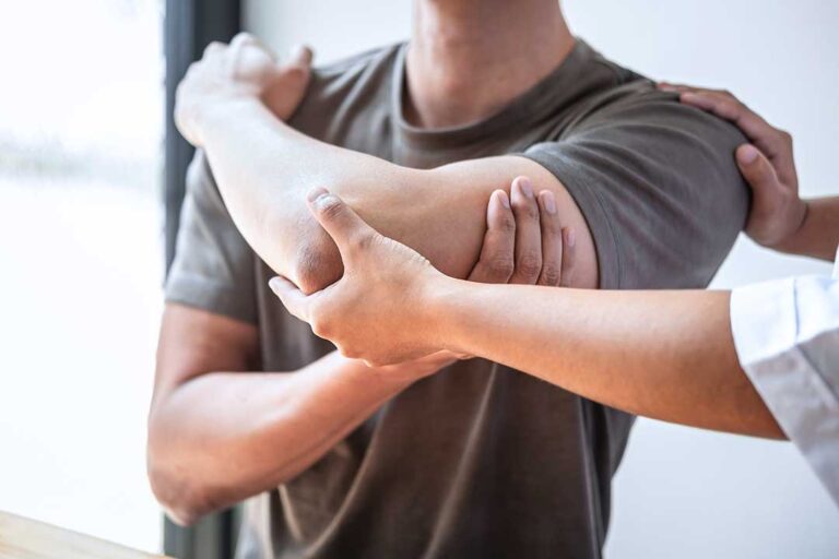 A chiropractor gently manipulating a patient's back in a well-lit clinic setting.